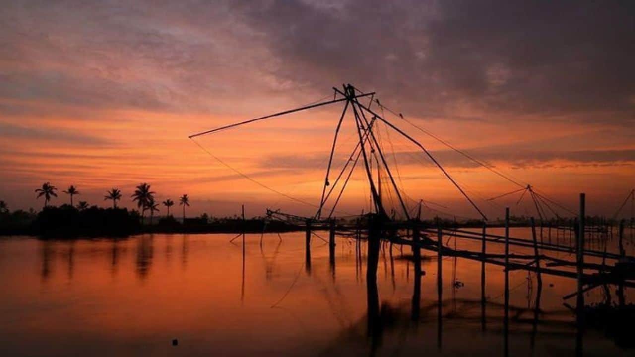 A-fishing-net-silhouetted-against-a-vibrant-sunset-in-Muziris-India.jpg
