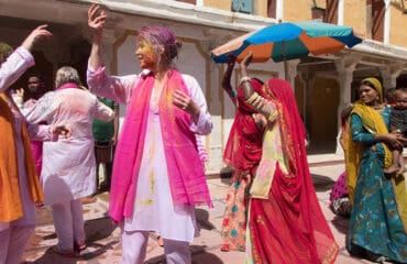 A-group-of-people-in-vibrant-clothing-joyfully-dancing-at-a-celebration-in-Chanoud-Garh-India.jpg
