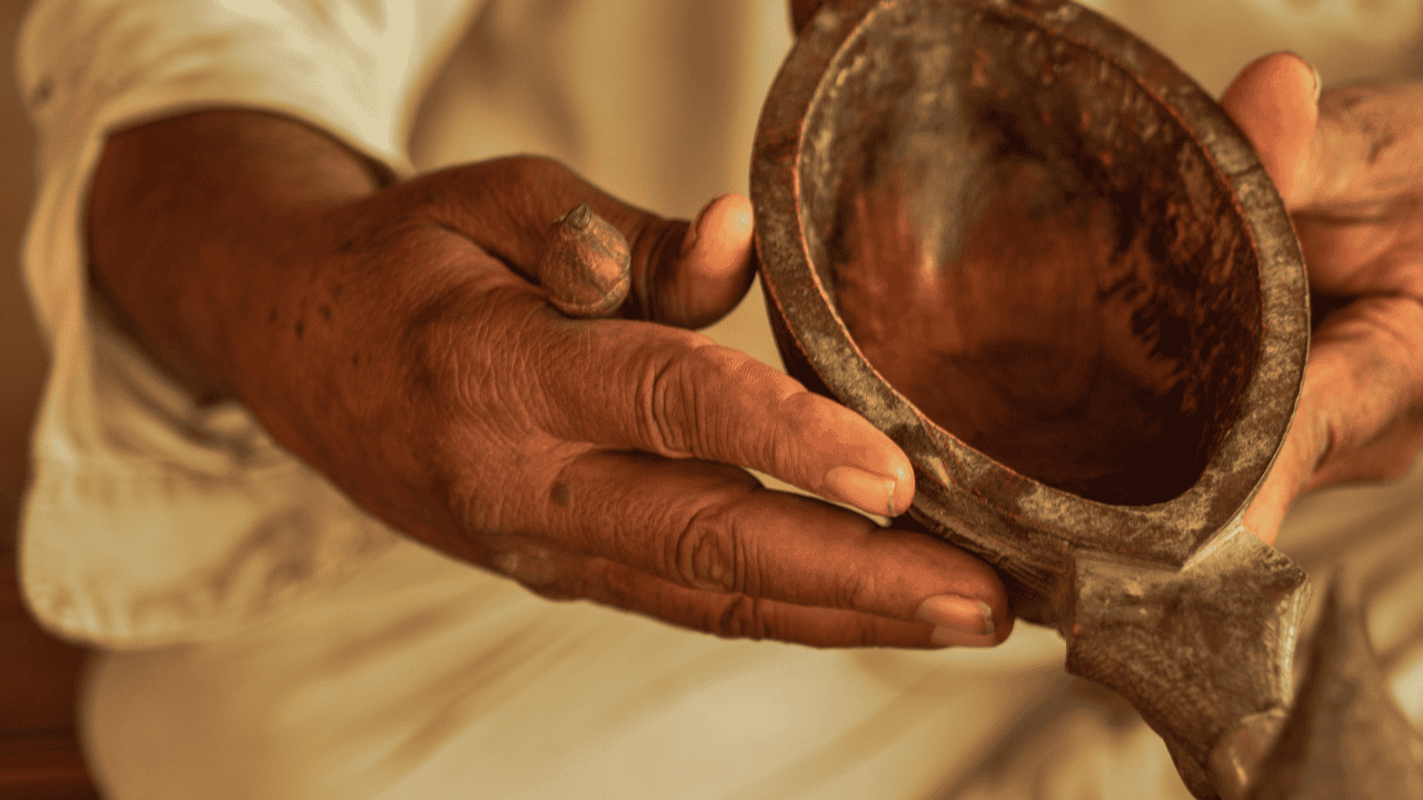 A-man-in-Bishnoi-Village-India-holds-a-bowl-in-his-hands.png