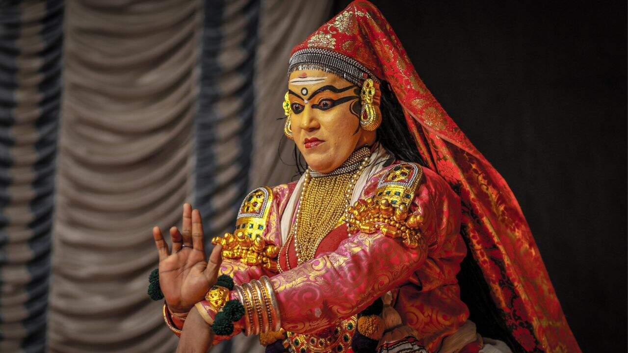 A-man-in-traditional-Kathakali-costume-performing-a-vibrant-dance-in-India.jpg