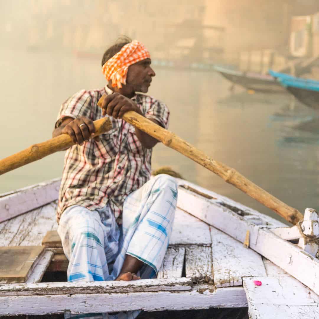 A man navigates a boat on the Ganges River in Varanasi, India A man navigates a boat on the Ganges River in Varanasi India