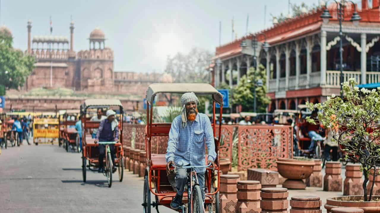 A-man-rides-a-rickshaw-in-front-of-the-iconic-Red-Fort-during-an-Old-Delhi-rickshaw-ride.jpg