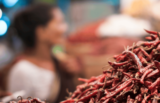 A-market-scene-in-Wayanad-featuring-a-pile-of-bright-red-peppers-555x360.png