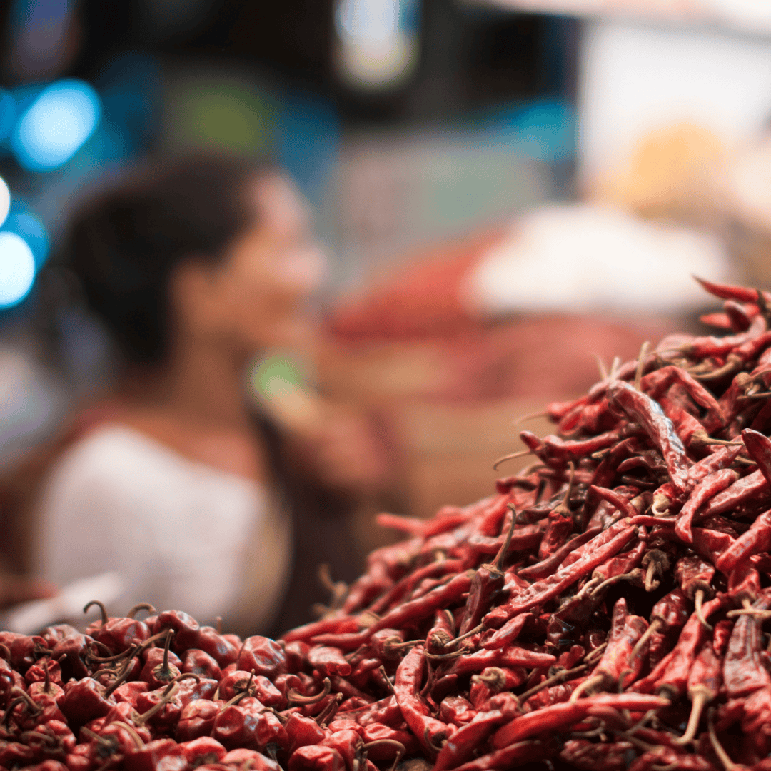 A market scene in Wayanad featuring a pile of bright red peppers A market scene in Wayanad featuring a pile of bright red peppers