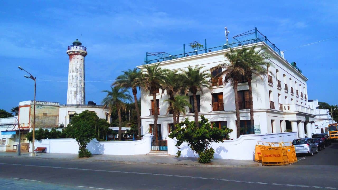 A-white-building-with-a-prominent-lighthouse-representing-Pondicherrys-unique-coastal-landscape.jpg
