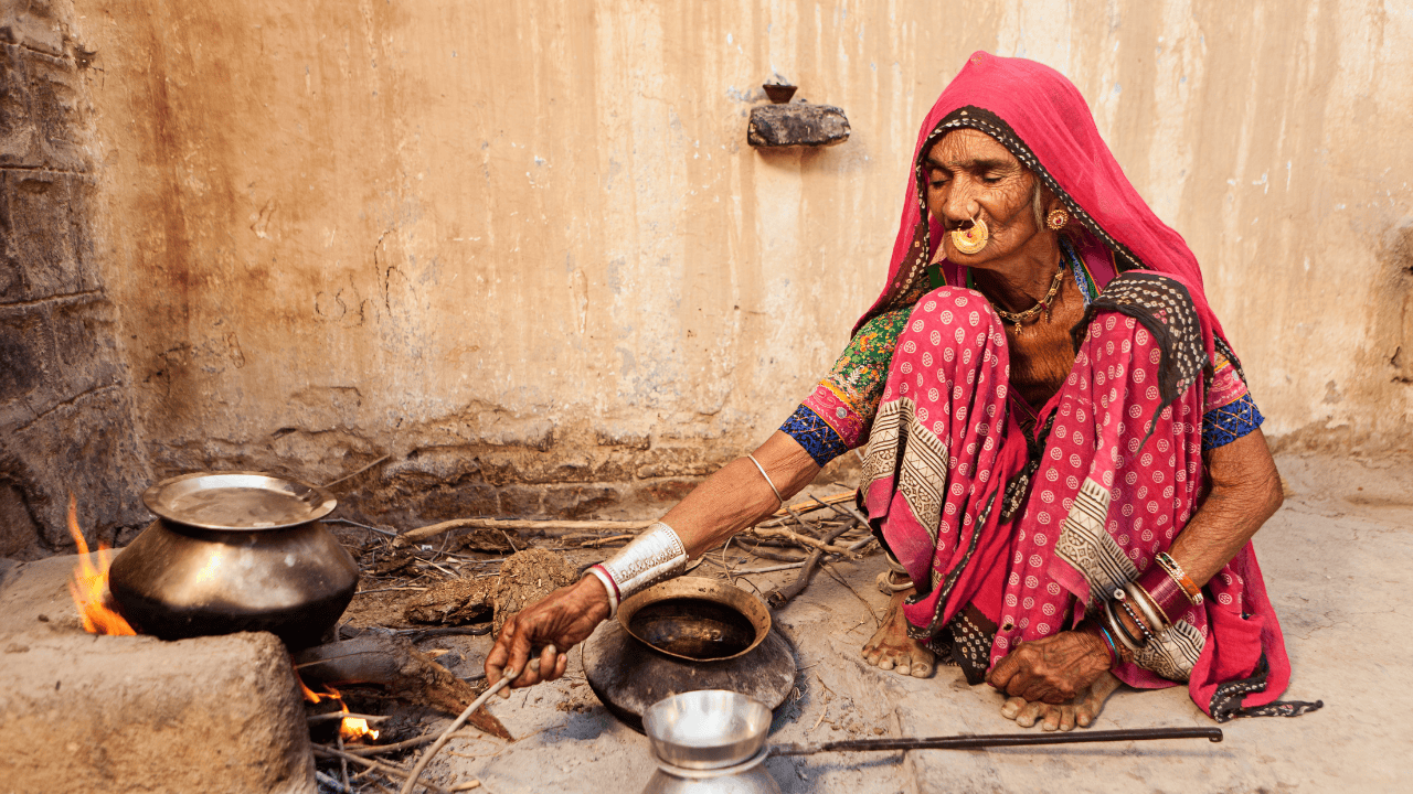 A-woman-preparing-a-meal-in-a-kitchen-in-Bishnoi-Village-India.png
