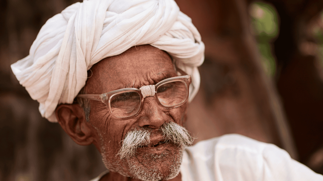 An-old-man-with-glasses-and-a-turban-captured-in-Bishnoi-Village-India.png