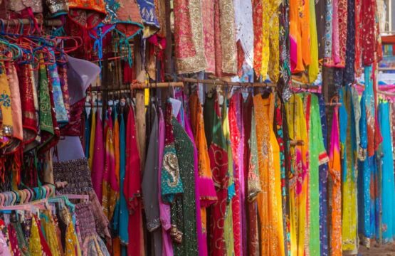 Colorful-saris-displayed-for-sale-at-a-bustling-market-in-Jaipur-India-555x360.jpg