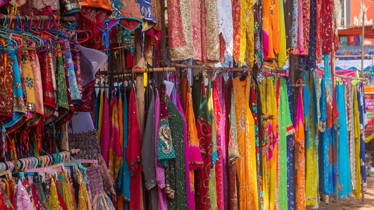 Colorful-saris-displayed-for-sale-at-a-bustling-market-in-Jaipur-India.jpg