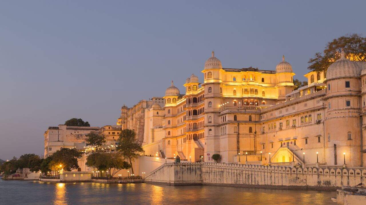 Dusk-view-of-the-Palace-of-Udaipur-highlighting-its-majestic-structure-and-reflections-on-the-water-in-Udaipur-India.jpg