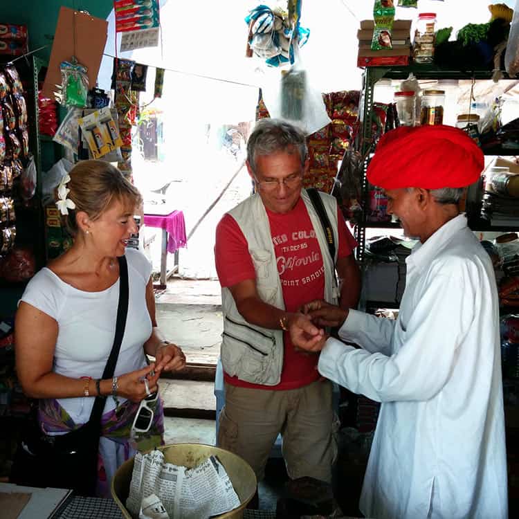 In Chanoud Garh, India, a man is seen wearing a red hat, showcasing a blend of culture and tradition In Chanoud Garh, India, a man is seen wearing a red hat, showcasing a blend of culture and tradition