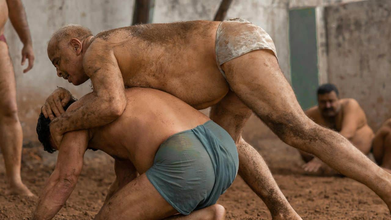 Men-wrestling-in-the-dirt-during-a-kushti-match-highlighting-the-cultural-sport-of-Varanasi.jpg