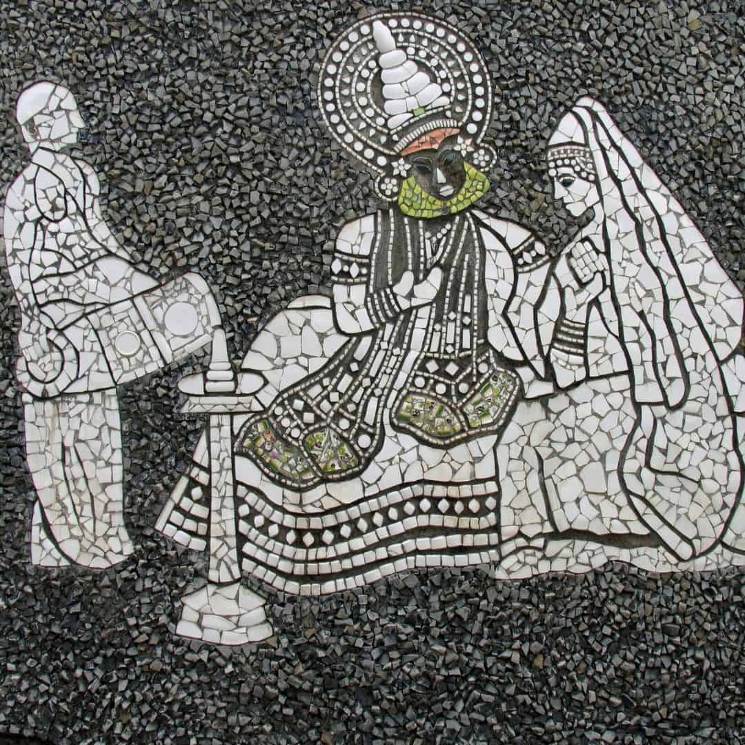 Mosaic artwork of a couple on a stone, illustrating the vibrant atmosphere of a Kathakali dance performance in India Mosaic artwork of a couple on a stone illustrating the vibrant atmosphere of a kathakali dance performance in India