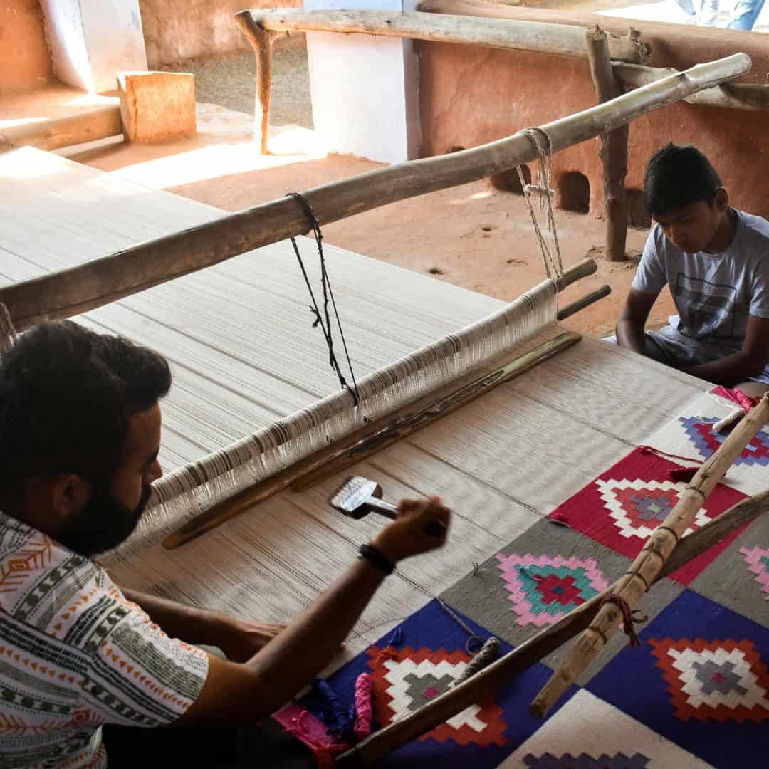 Two men operate a weaving loom in Jodhpur, India Two men operate a weaving loom in Jodhpur India