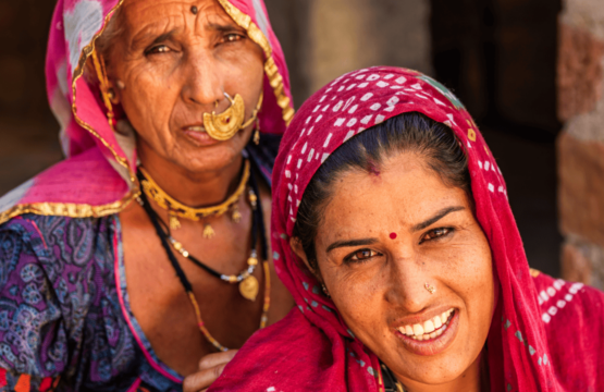 Two-women-in-colorful-saris-smiling-at-the-camera-in-Bishnoi-Village-India-555x360.png