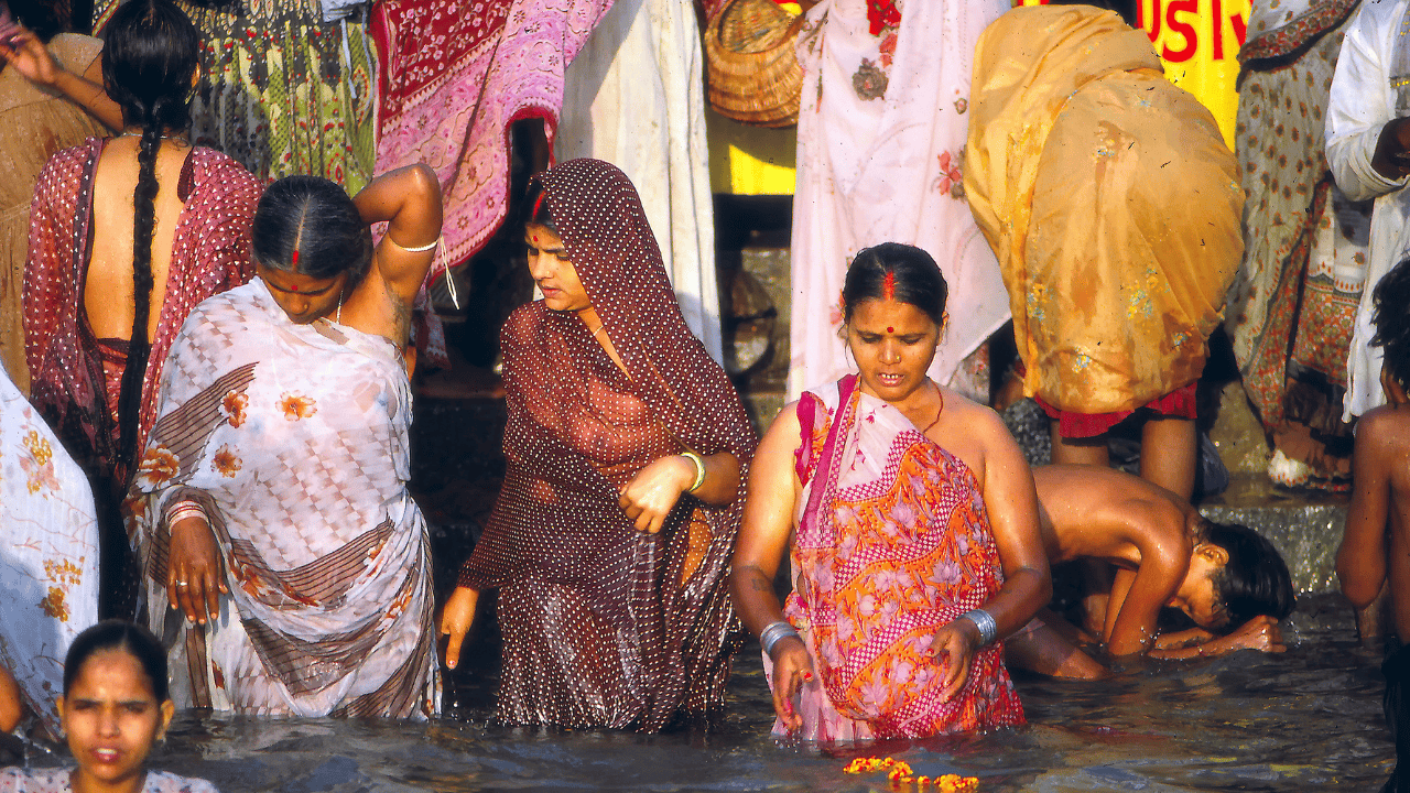 Women-bathing-in-the-Ganges-River-in-Varanasi-India-surrounded-by-ancient-temples-and-vibrant-cultural-scenery.png