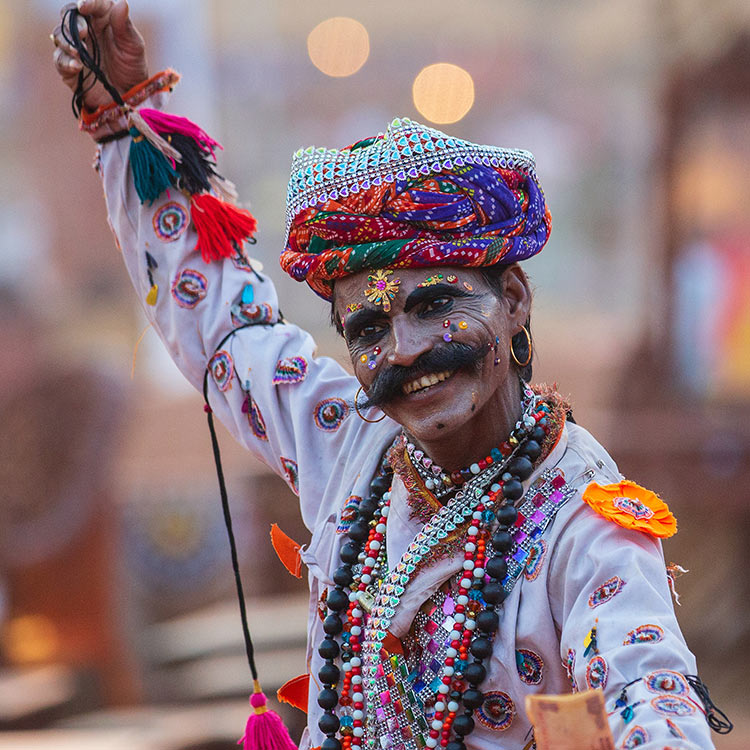 A man with a moustache wearing a vibrant, colorful headdress, representing traditional Indian attire A man with a moustache wearing a vibrant colourful headdress representing traditional Indian attire