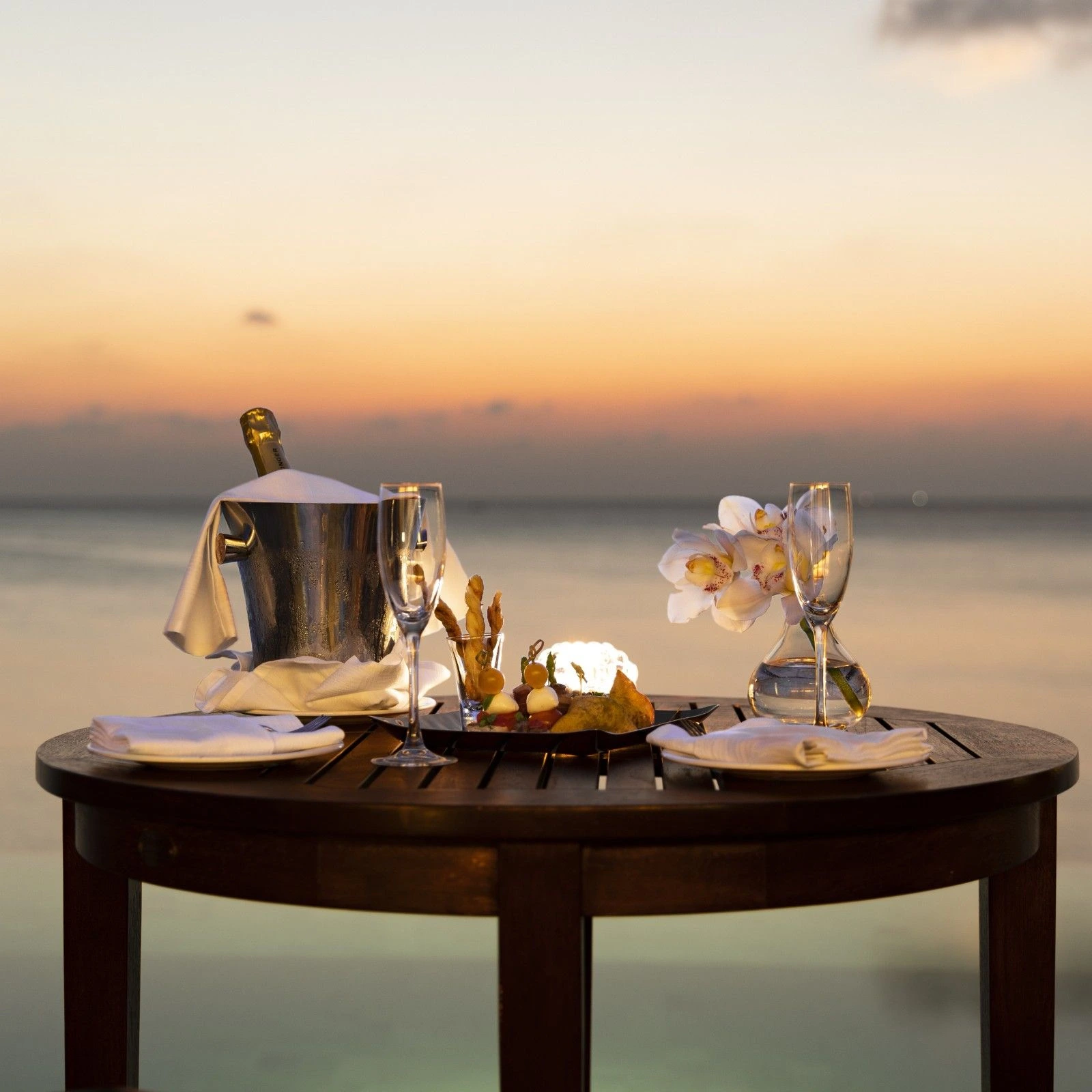 Anantara_Dhigu_Maldives_Resort_Guest_Room_Over_Water_Pool_Suite_Sunset_with_Cocktails_on_the_Table (1)